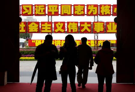 People visit Beijing Exhibition Centre for an exhibition displaying China's achievements for the past five years in Beijing, as the capital prepares for the 19th National Congress of the Communist Party of China, October 10, 2017. The words on the sign read, "Unite closely around the Party Central Committee with Comrade Xi Jinping as the core, push forward the great cause of socialism with Chinese characteristics". REUTERS/Jason Lee