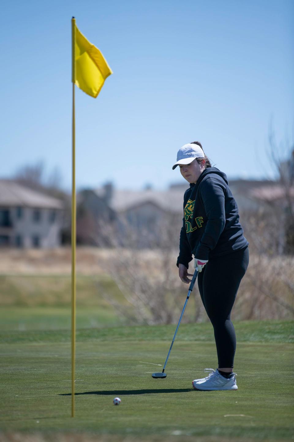 Pueblo County's Samantha Hansen watches her ball after a putt on the 13th green during the Centennial girls golf tournament at Walking Stick Golf Course on Wednesday, April 6, 2022.