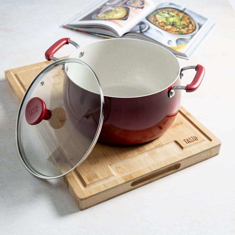 The red dutch oven on a cutting board