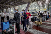 Chinese tourists from Shanghai arrive at Suvarnabhumi airport on special tourist visas, in Bangkok, Thailand, Tuesday, Oct. 20, 2020. Thailand on Tuesday took a modest step toward reviving its coronavirus-battered tourist industry by welcoming 39 visitors who flew in from Shanghai, the first such arrival since normal traveler arrivals were banned almost seven months ago. (AP Photo/Wason Wanichakorn)