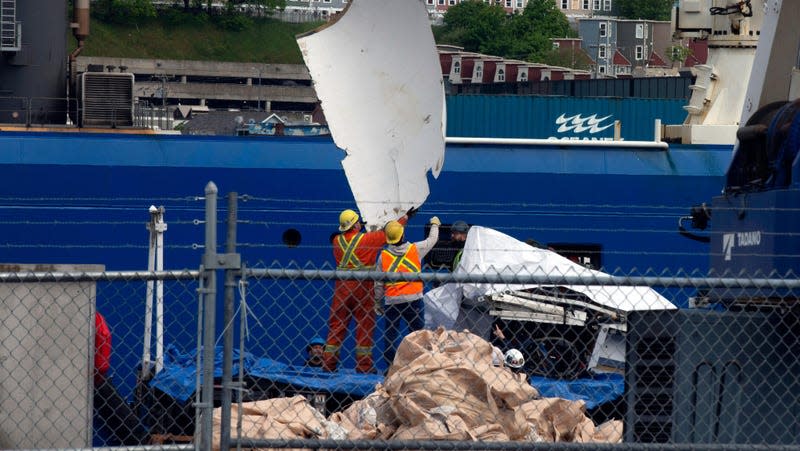 Wreckage recovered from the Titan submersible is unloaded in Newfoundland. 