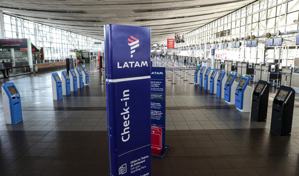 The check-in area for Latam airplanes is empty at the Arturo Merino Benitez airport in Santiago, Chile, Tuesday, May 26, 2020. South America’s biggest carrier is seeking U.S. bankruptcy protection as it grapples with a sharp downturn in air travel sparked by the coronavirus pandemic. (AP Photo/Esteban Felix)