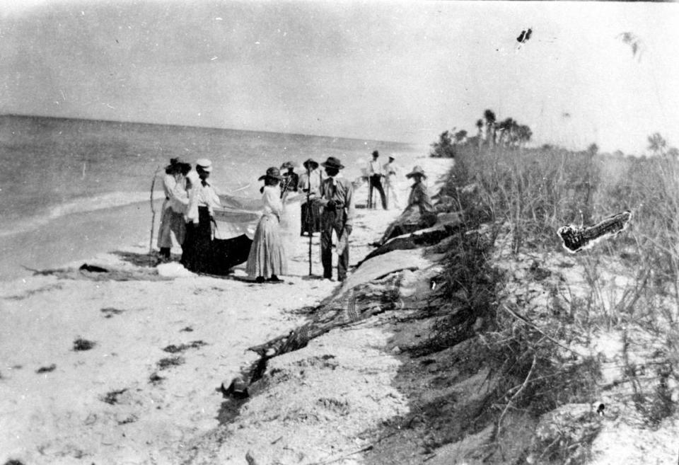 A party of campers on the beach at Anna Maria between 1910 and 1915. It looks like they are handling fishing nets.