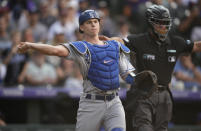 Los Angeles Dodgers catcher Will Smith throws to first base to put out Colorado Rockies' Brendan Rodgers in the ninth inning of a baseball game Thursday, Sept. 23, 2021, in Denver. (AP Photo/David Zalubowski)