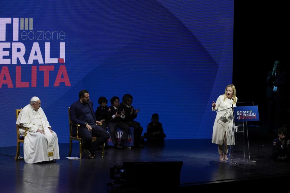 Giorgia Meloni delivers her speech as Pope Francis and Gigi de Palo listen during conference on birthrate, at Auditorium della Conciliazione, in Rome, Friday, May 12, 2023. (AP Photo/Alessandra Tarantino)