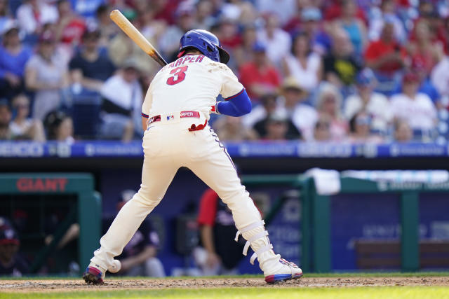 Harper's 2 HRs help Phils top Nats 12-3, push champs to edge NATS