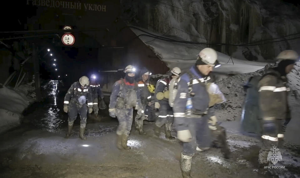 In this grab taken from video released by the Russia Emergency Situations Ministry press service on Sunday, March 24, 2024, Russia Emergency Situations employees leave the collapsed gold mine in Zeysk district, Amur region, eastern Russia. At least 13 miners continue to be trapped in a collapsed gold mine in far eastern Russia. (Russia Emergency Situations Ministry press service via AP)