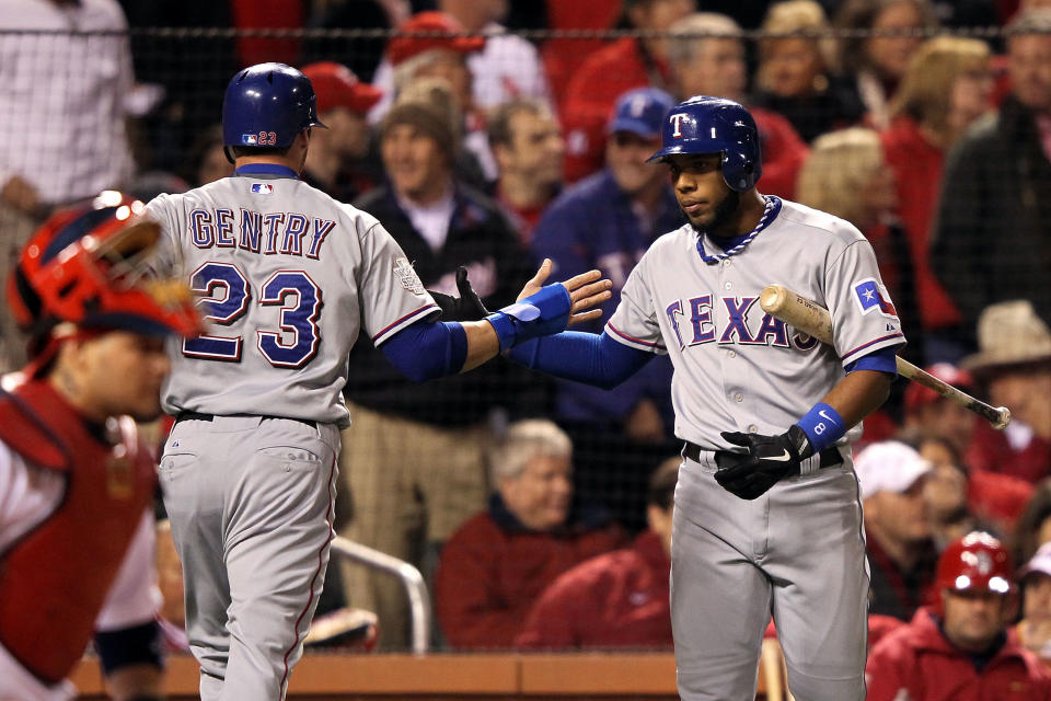 ST LOUIS, MO - OCTOBER 27: Craig Gentry #23 and Elvis Andrus #1 of the Texas Rangers celebrate after Gentry scores on a RBI double by Ian Kinsler #5 in the second inning during Game Six of the MLB World Series against the St. Louis Cardinals at Busch Stadium on October 27, 2011 in St Louis, Missouri. (Photo by Jamie Squire/Getty Images)