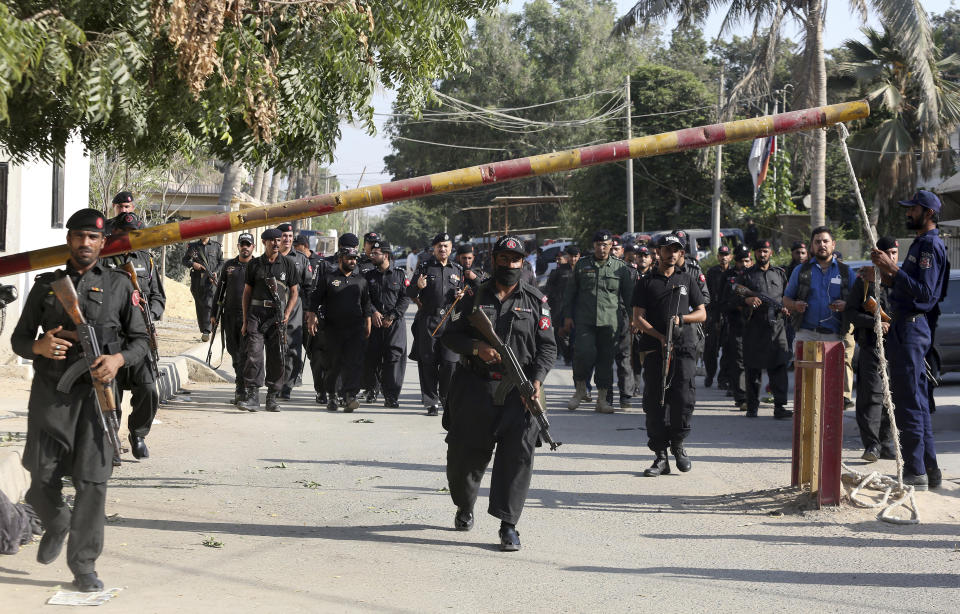 Pakistani security personnel arrive at the Chinese Consulate following Friday's attack on the premises in Karachi, Pakistan, Saturday, Nov. 24, 2018. Pakistani police say the suicide bomber that struck the country's Chinese consulate used foreign-made C-4 plastic explosive and suggested the attack was orchestrated in India. (AP Photo/Shakil Adil)