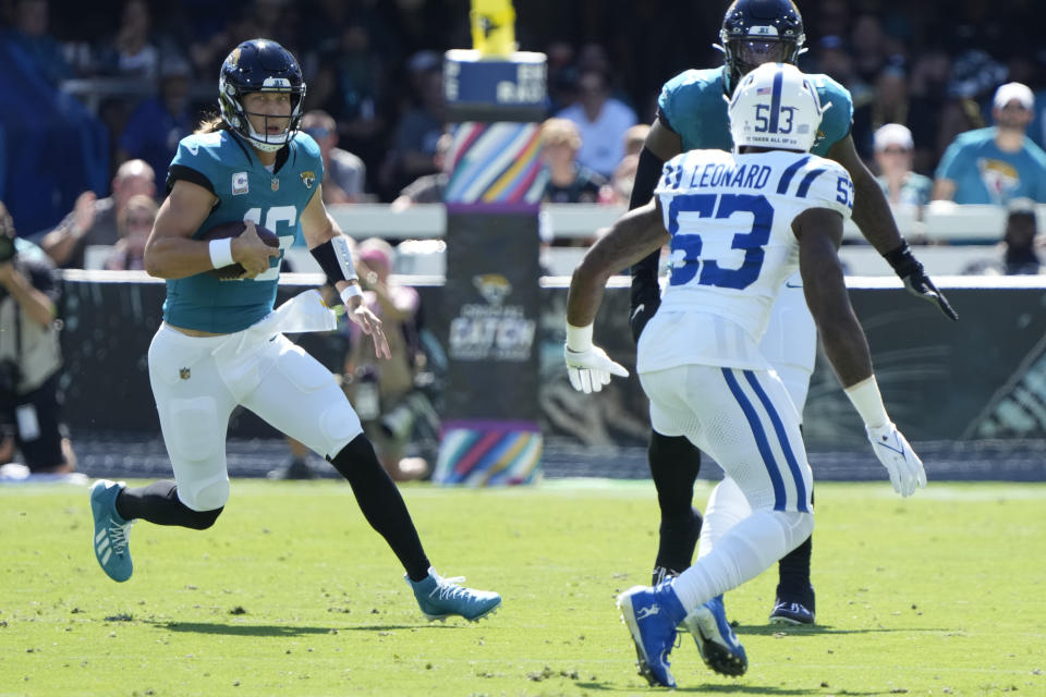 Jacksonville Jaguars quarterback Trevor Lawrence (16) scrambles as Indianapolis Colts linebacker Shaquille Leonard (53) defends during the first half of an NFL football game, Sunday, Oct. 15, 2023, in Jacksonville, Fla. (AP Photo/John Raoux)