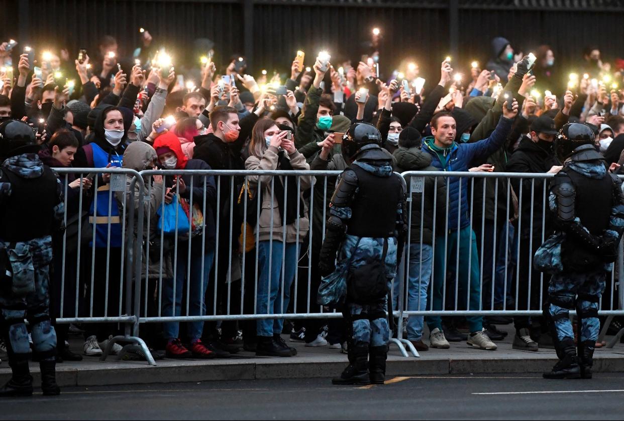 Protesters hold phones with flashlights turned on during a rally in support of jailed Russian opposition activist Alexei Navalny in Moscow on April 21.