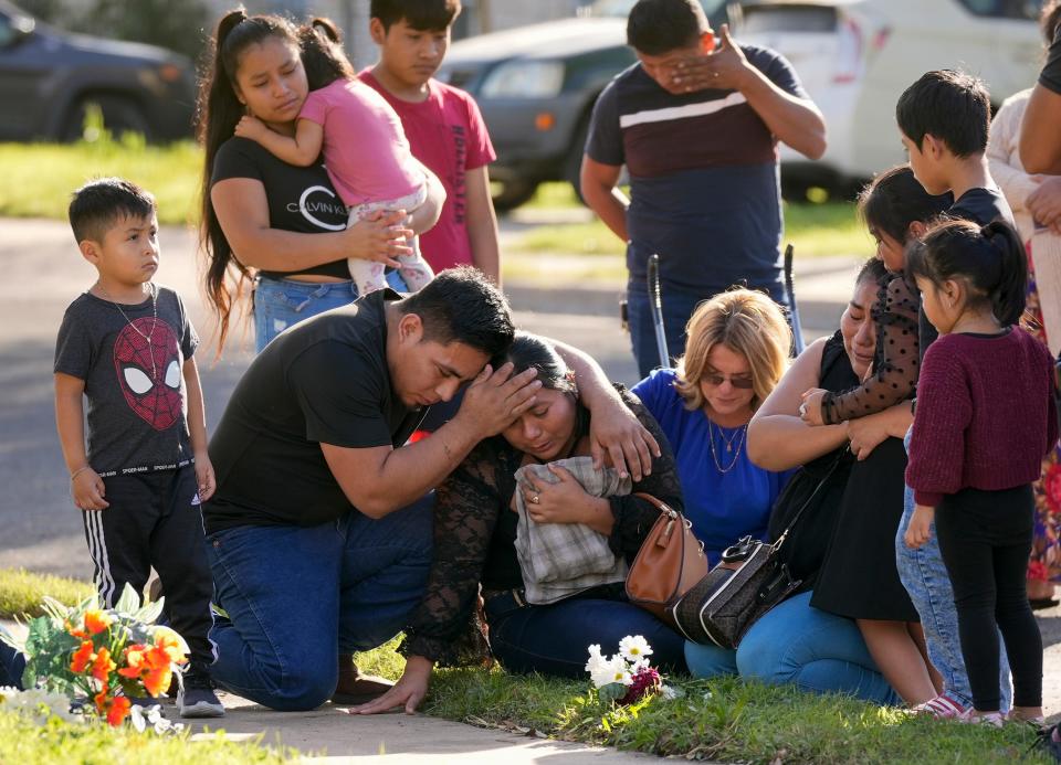Domatilia Caal is consoled on Wednesday December 6, 2023, by her brother, Cornelio Caal, at the site on Shadywood Lane in South Austin where her husband was killed on Tuesday.