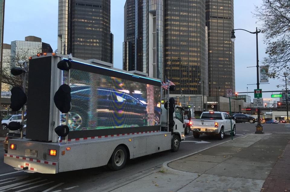 Surveillance video of Mayor Mike Duggan's movements that was paid for by Detroit businessman Robert Carmack plays on the screen of a mobile billboard on Nov. 14, 2018, as Carmack battled the city over a piece of property he claimed was his.