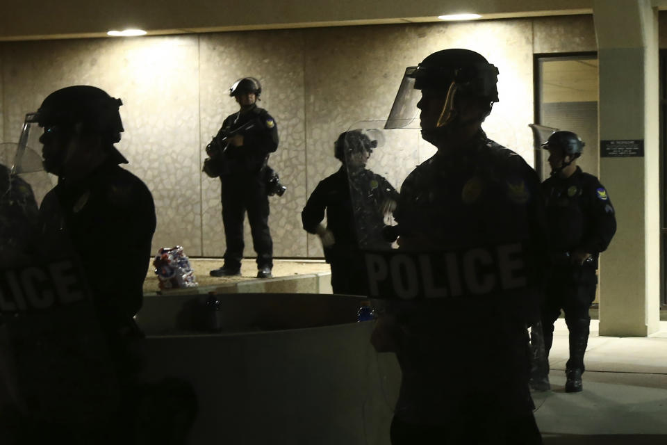 Officers stand in front of the Phoenix police headquarters on May 30, 2020. (Ross D. Franklin / AP file)