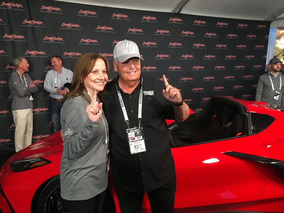 GM CEO Mary Barra and Corvette collector Rick Hendrick at the auction block where Henrdrick paid $3 million for VIN #0001 of the first mid-engine Corvette.