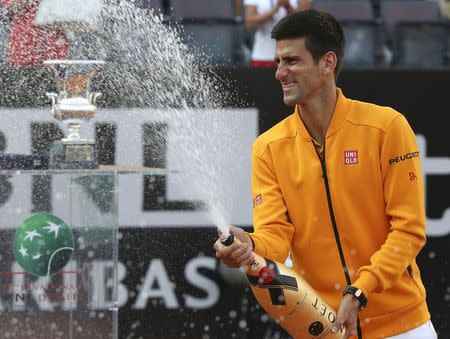 Novak Djokovic of Serbia sprays champagne after winning the final match over Roger Federer of Switzerland at the Rome Open tennis tournament in Rome, Italy, May 17, 2015. REUTERS/Stefano Rellandini