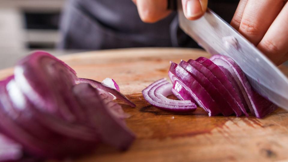 Red onion on chopping board