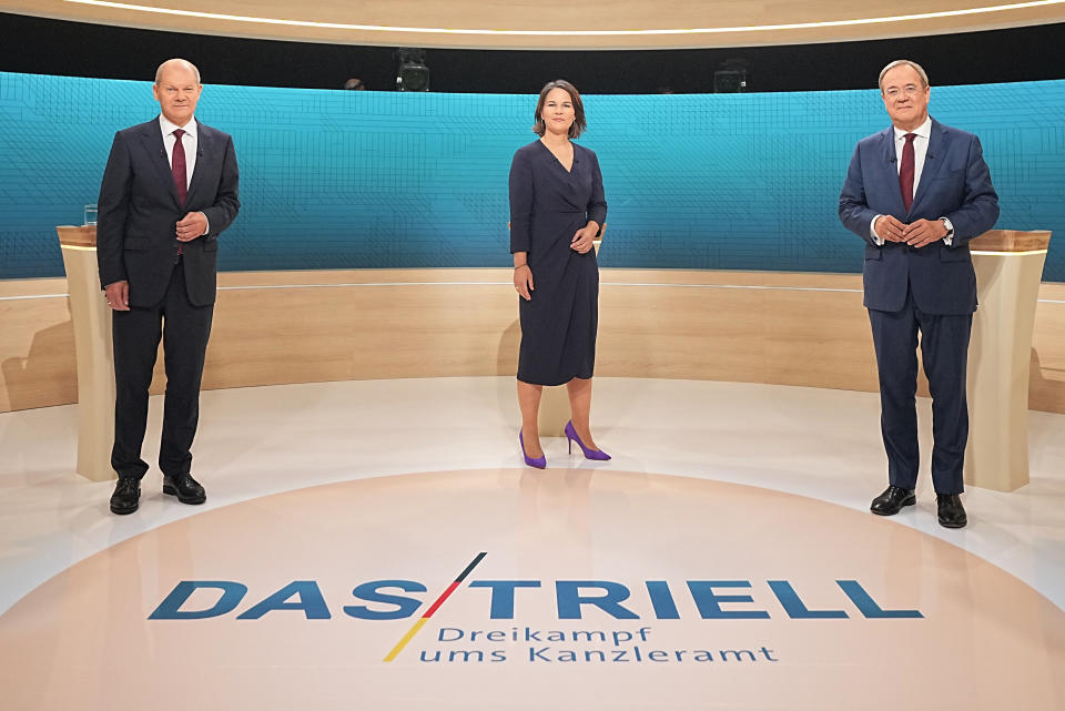 From left, Chancellor candidates Olaf Scholz (SPD), Annalena Baerbock (Green Party) and Armin Laschet (CDU) stand in the TV studio in Berlin, Sunday, Sept. 12, 2021. With two weeks left before Germany’s national election, the three candidates for chancellorship are facing off Sunday in the second of three televised election debates. (Michael Kappeler/Pool via AP)