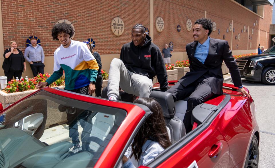 Kendall Brown (left), Bennedict Mathurin, and Andrew Nembhard, new draft picks, load into a convertible to meet fans Friday, June 24, 2022, before the players’ introduction at Ascension St. Vincent Center, the Pacers practice facility. 