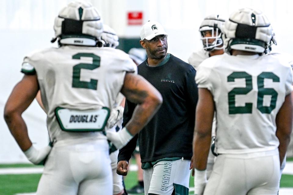 Michigan State's defensive line coach Marco Coleman works with players during practice on Tuesday, March 29, 2022, at the indoor football facility in East Lansing.
