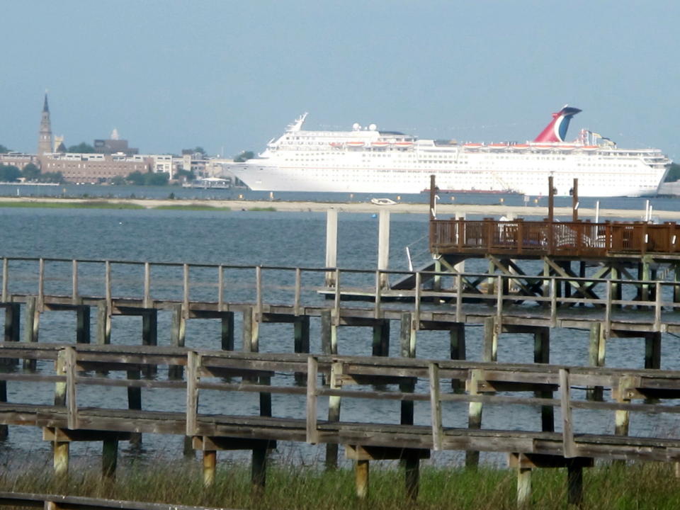 This April 18, 2012, photo taken from the Mount Pleasant, S.C. side of the Cooper River shows the Carnival Fantasy at a dock in Charleston. For more than two years the debate over cruise ships calling year-round in Charleston has raged with a state Supreme Court case, conflicting economic studies and rhetoric. Preservationists cite the threat to the city's historic character while cruise supporters say the industry is being administered appropriately and provides needed jobs and a boost to the local economy. (AP Photo/Bruce Smith)