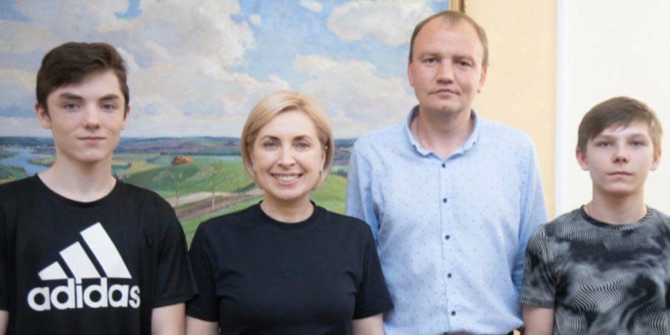 Ukrainian Vice Prime Minister Iryna Vereshchuk poses for a photo with teens Ivan, left, and Maxim, far right, along with the man who spent 72 hours on buses to go and rescue them from Russia. / Credit: Courtesy of Iryna Vereshchuk