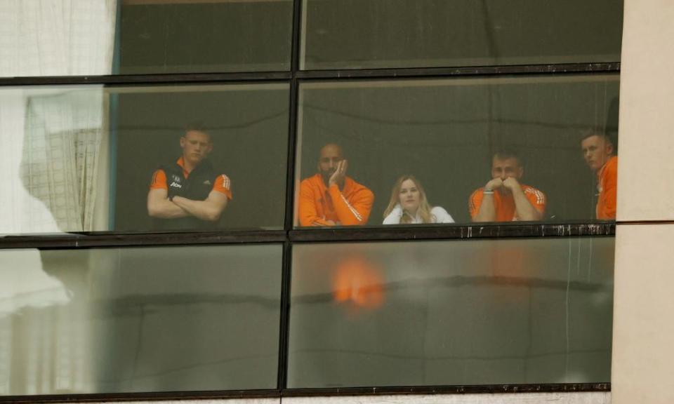 Scott McTominay, Luke Shaw and Lee Grant watch the protest from the window of the Lowry hotel