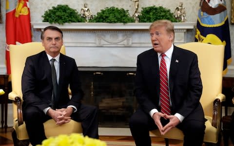 President Donald Trump meets with Brazilian President Jair Bolsonaro in the Oval Office of the White House - Credit: AP