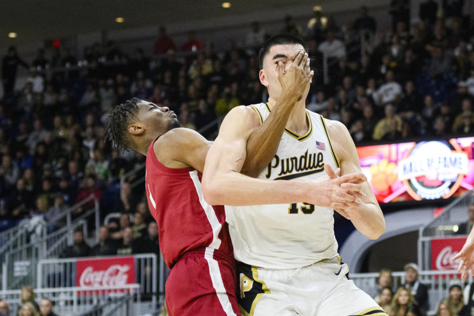 Purdue center Zach Edey (15) is hit in the face by Alabama forward Mohamed Wague (11) during the second half of an NCAA college basketball game in Toronto, Saturday, Dec. 9, 2023. (Christopher Katsarov/The Canadian Press via AP)