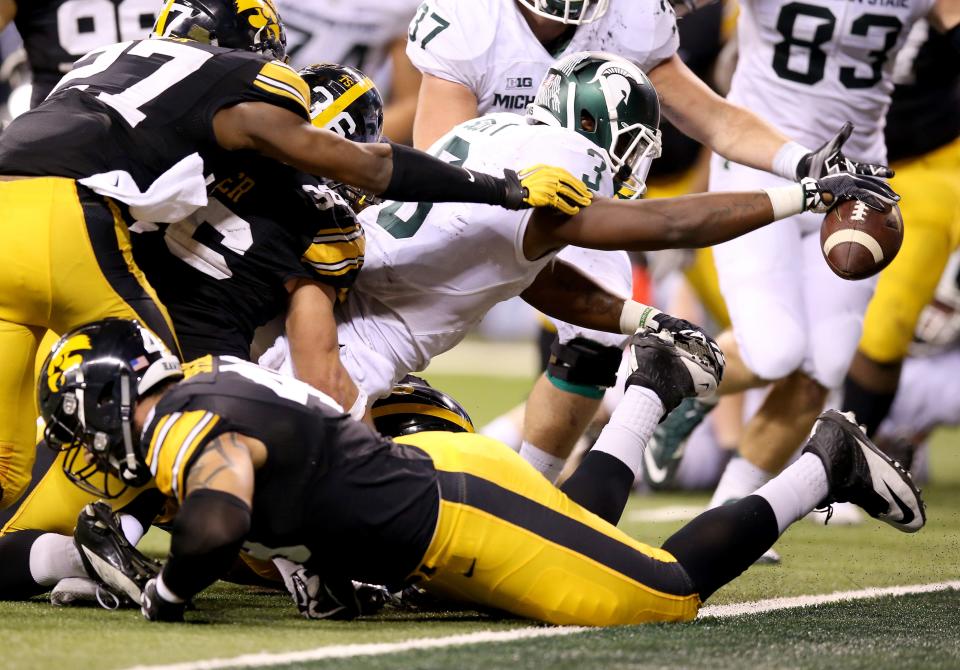INDIANAPOLIS, IN - DECEMBER 05:  LJ Scott #3 of the Michigan State Spartans reaches into the end zone against the Iowa Hawkeyes in the Big Ten Championship at Lucas Oil Stadium on December 5, 2015 in Indianapolis, Indiana.