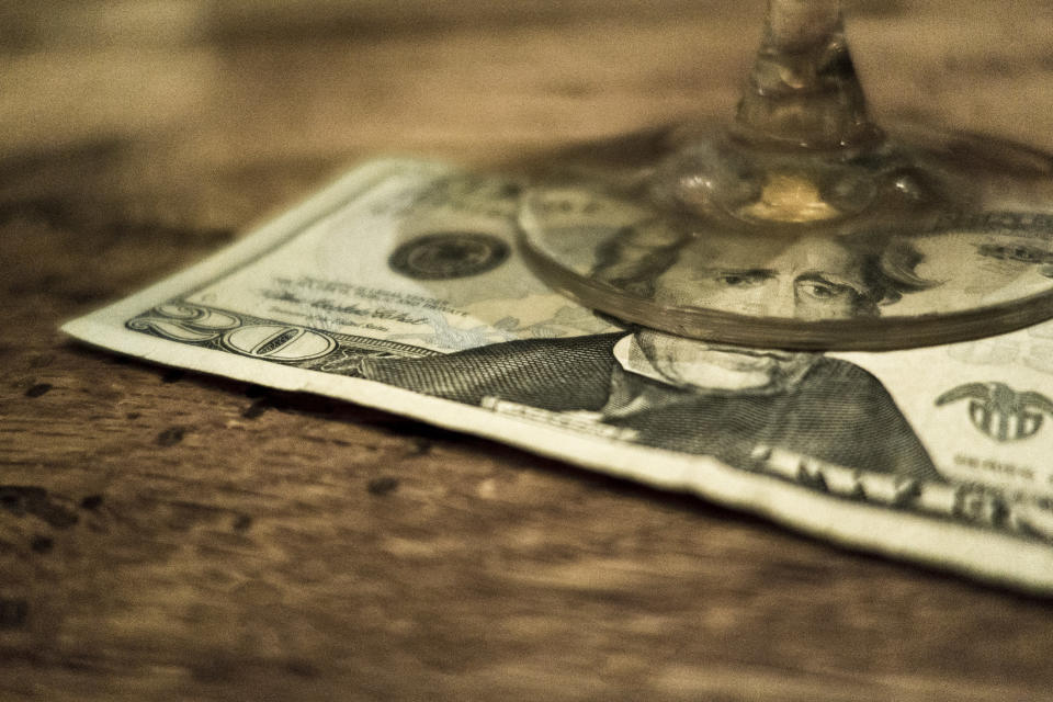 $20 bill under a glass in a restaurant