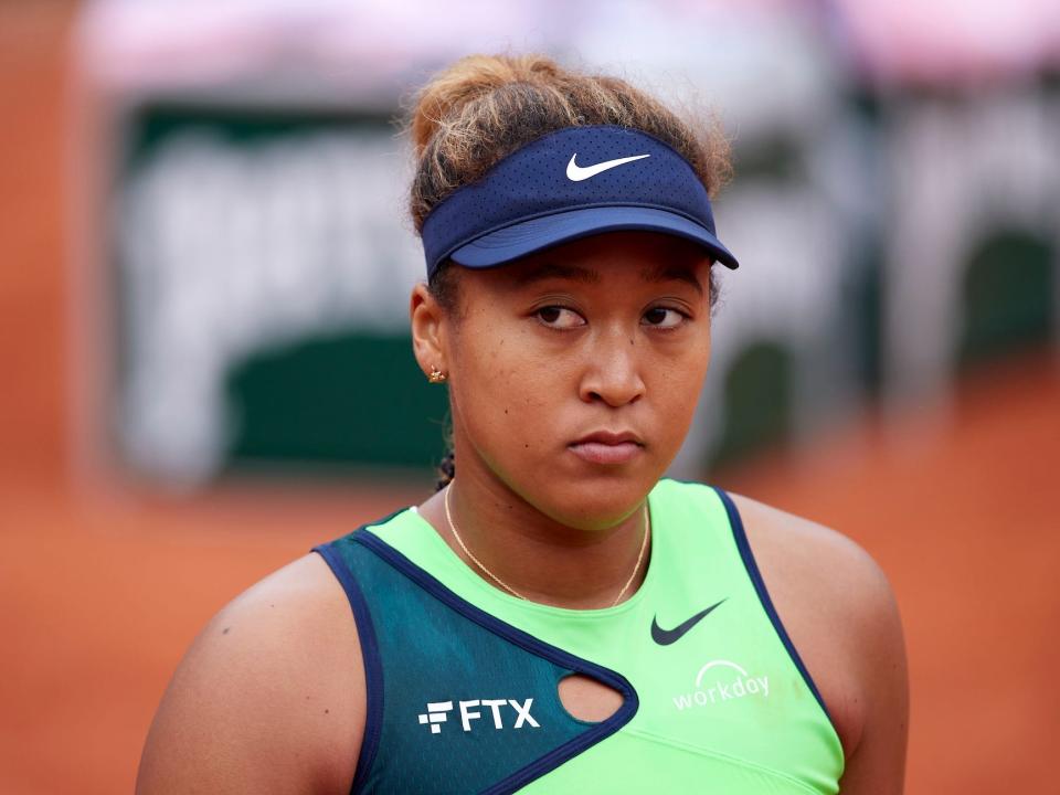 Naomi Osaka of Japan looks on against Amanda Anisimova of United States in their first round match during day two of the 2022 French Open at Roland Garros