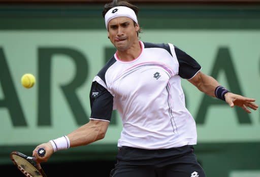 Spain's David Ferrer hits a return to Rafael Nadal during their semi-final match at the French Open on June 8. Nadal defeated fellow Spaniard Ferrer 6-2, 6-2, 6-1 on Friday to reach the French Open final where he will bid to become the first man to win seven titles at Roland Garros