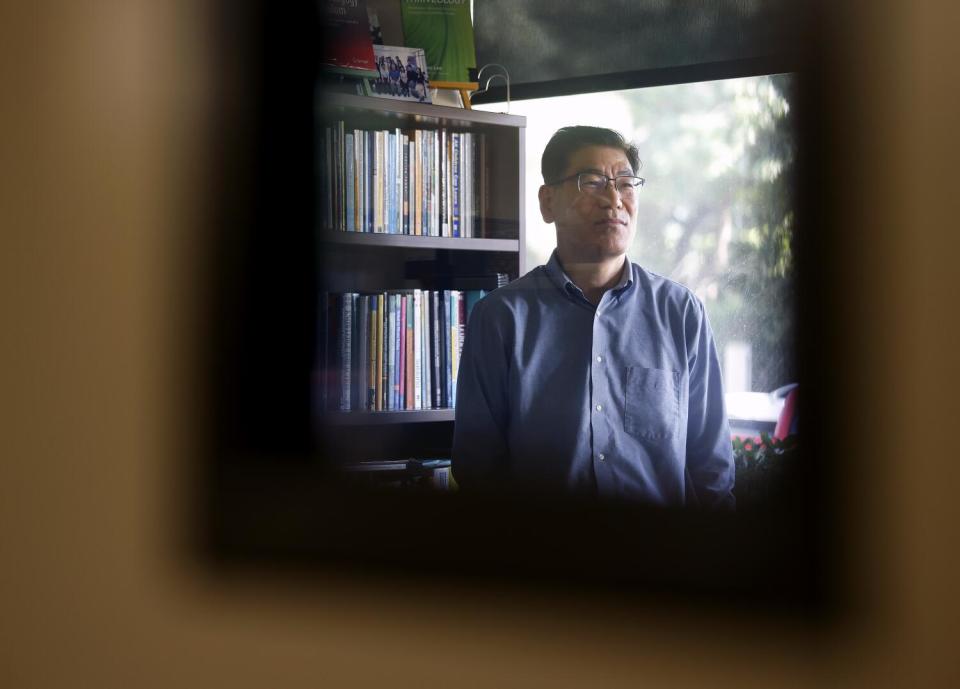 HeeKap Lee stands in his office.