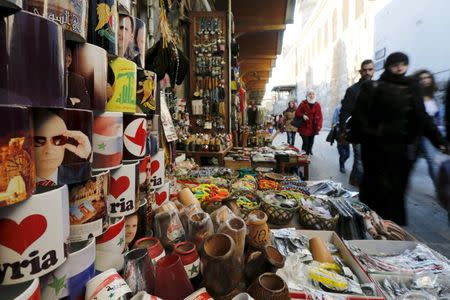 Souvenir mugs featuring Syria's President Bashar al-Assad, Russia's President Vladimir Putin and Lebanon's Hezbollah leader Sayyed Hassan Nasrallah are seen among other items for sale in old Damascus, Syria, February 8, 2016. REUTERS/Omar Sanadiki