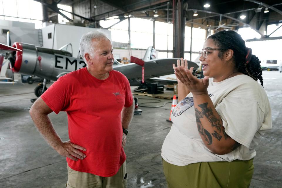 Wayne Lusardi, Michigan's state maritime archaeologist with the Department of Natural Resources, left, talks with Isis Gillespie, Tuskegee Airmen National Historical Museum's conservator of the P-39 at the museum, Thursday, Aug. 17, 2023, in Detroit.