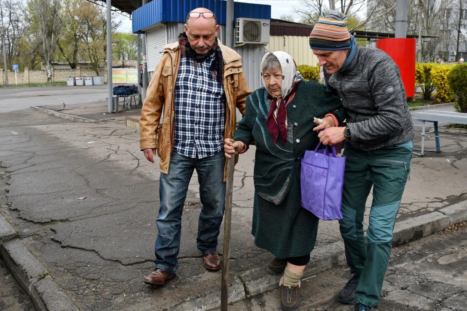 Men help Maria Dyachenko, 83, board a transport during evacuation of civilians in Kramatorsk, Ukraine, on April 12, 2022. Dyachenko said her village of Dovhenke was completely destroyed during fighting between Russian and Ukrainian forces.