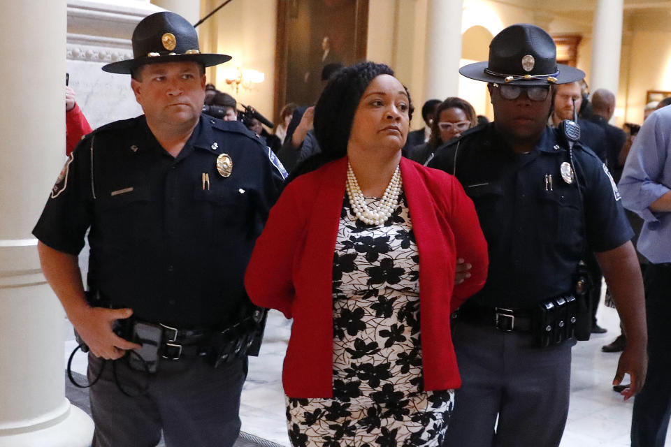 FILE - In this Tuesday, Nov. 13, 2018 file photo, Sen. Nikema Williams, D-Atlanta, is detained by capitol police during a protest over election ballot counts in the rotunda of the state capitol building, in Atlanta. "The 2020 election cycle is going to be key to changing the course of history in this country," says Williams, chair of the Democratic party of Georgia, who was selected to replace the late Rep. John Lewis, the civil rights icon who died in July, on the November ballot. "We're a battleground in Georgia now, and Black women are leading the way." (AP Photo/John Bazemore, File)