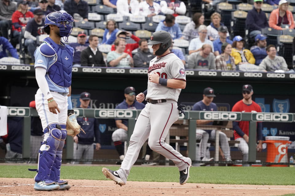 Minnesota Twins' Caleb Hamilton crosses the plate past Kansas City Royals catcher MJ Melendez to score on a sacrifice fly hit by Nick Gordon during the sixth inning of a baseball game Thursday, Sept. 22, 2022, in Kansas City, Mo. (AP Photo/Charlie Riedel)