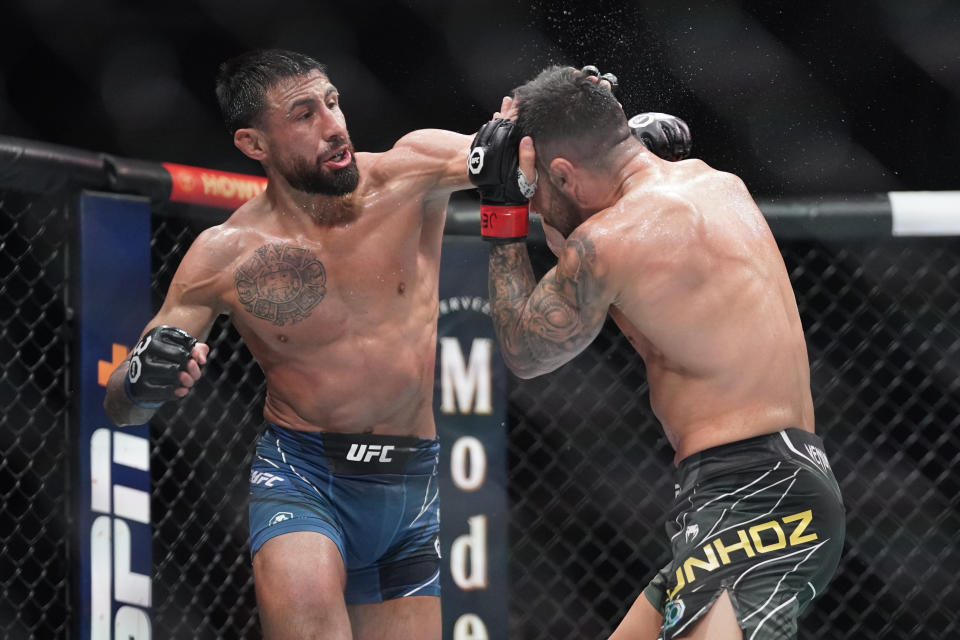 Apr 15, 2023; Kansas City, Missouri, USA; Pedro Munhoz (red gloves) fights Chris Gutierrez (blue gloves) during UFC Fight Night at T-Mobile Center. Mandatory Credit: Denny Medley-USA TODAY Sports