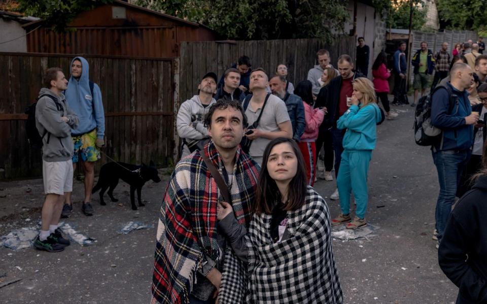 People gather outside a residential building damaged during Russian drone attacks in Kyiv - Roman Pilipey/Getty Images Europe