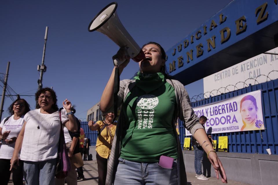 FILE - In this Dec. 13, 2017 file photo, women protest outside a courtroom, demanding that the government free women prisoners who are serving 30-year sentences for having an abortion, in San Salvador, El Salvador. A young woman who birthed a baby into a toilet in El Salvador faces a second trial for murder on Monday, July 14, 2019 in a case that has drawn international attention because of the country's highly restrictive abortion laws. (AP Photo/Salvador Melendez, File)