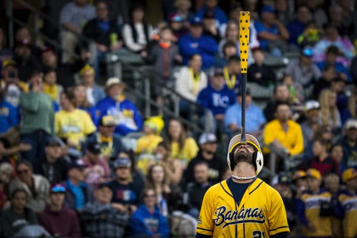 Savannah Bananas player Alex Ziegler balances his baseball bat on his forehead.