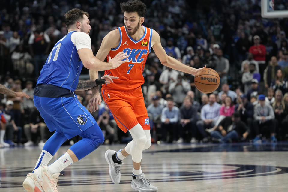 Oklahoma City Thunder forward Chet Holmgren (7) dribbles against Dallas Mavericks guard Luka Doncic (77) during the second half of an NBA basketball game in Dallas, Saturday, Dec. 2, 2023. (AP Photo/LM Otero)