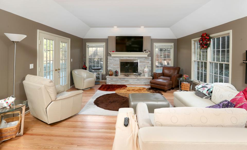 During the 2013 PGA Championship at Oak Hill Country Club, Tiger Woods and Lindsey Vonn, his girlfriend at the time, stayed at a 4,362-square-foot home on Pine Acres Drive in Pittsford. Pictured is its large sunken living room. The famed golfer left behind 15 items of memorabilia for the homeowners.