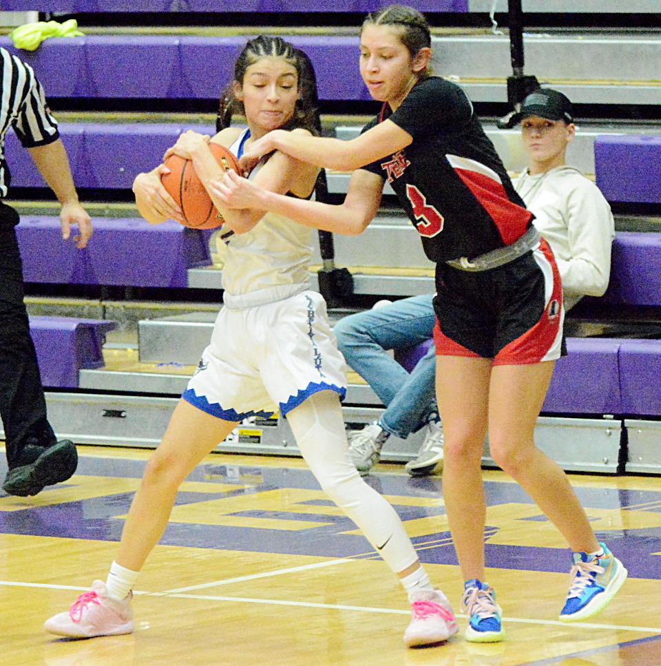 Red Cloud's Lolo Carlow attempts to keep the ball away from Lakota Tech's Taylor Byerley during their first-round game in the state Class A high school girls basketball tournament on Thursday, March 9, 2023 in the Watertown Civic Arena.