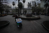 Painter Efren Cortes transports his paintings, including one of the late President Salvador Allende, on a dolly in the Plaza de Armas where he has been selling his paintings for over 30 years, in Santiago, Chile, Thursday, Aug. 31, 2023. The painting of Allende, which is not for sale but for display, was commissioned for the commemorative book "Chicho," Allende´s nickname, to mark the 50th anniversary of the military coup led by Gen. Augusto Pinochet that overthrew his government. (AP Photo/Esteban Felix)