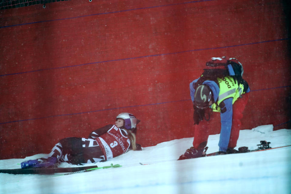 New Zealand's Alice Robinson, left, lies on the snow after crashing during an alpine ski, women's World Cup super G race, in Kvitfjell, Norway, Sunday, March 5, 2023. (Stian Lysberg Solum/NTB Scanpix via AP)