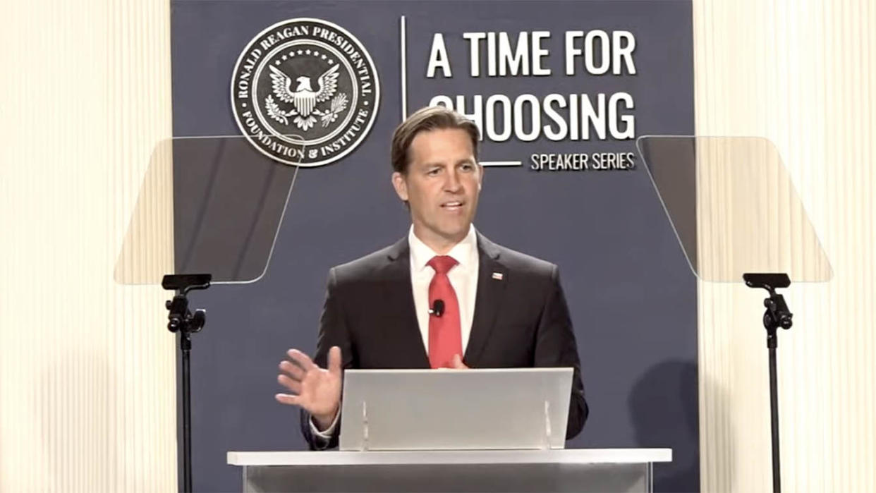 Sen. Ben Sasse, R-Neb., takes the podium with the Ronald Reagan presidential seal in the. background and written on the wall behind him: A Time for Choosing, Speaker Series.