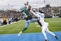 Tulane wide receiver Duece Watts (2) scores a touchdown against UCF cornerback Davonte Brown (7) during the first half of an NCAA college football game in New Orleans, Saturday, Nov. 12, 2022. (AP Photo/Matthew Hinton)